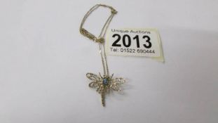 A fine gold dragonfly pendant on a fine gold chain, 1.9 grams.