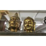 Two gilded Buddha heads.