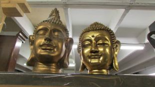 Two gilded Buddha heads.