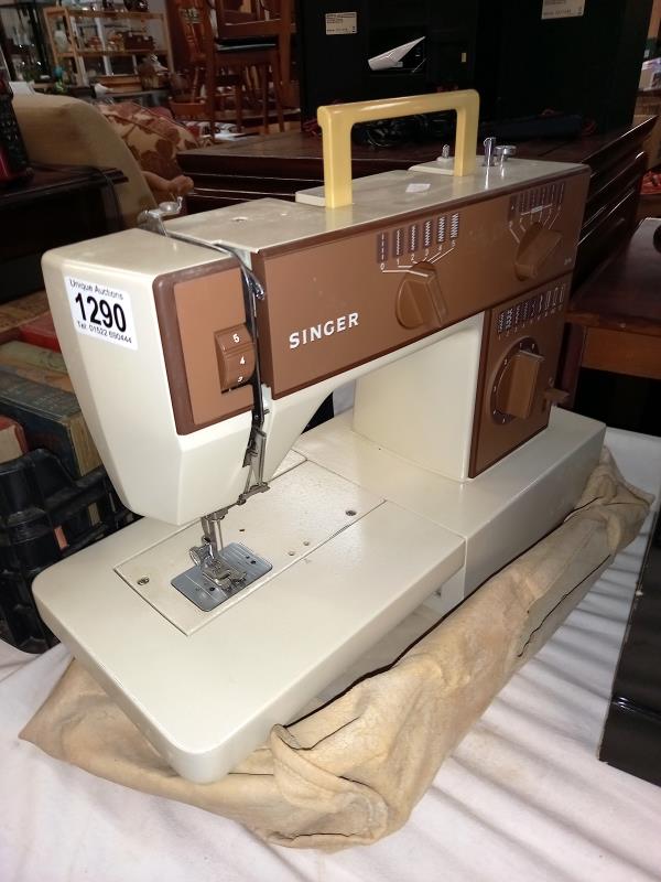 A Singer sewing machine with cloth cover COLLECT ONLY