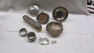 A silver dish, a silver shell dish, 2 silver napking rings, a silver rum lable (249 grams),