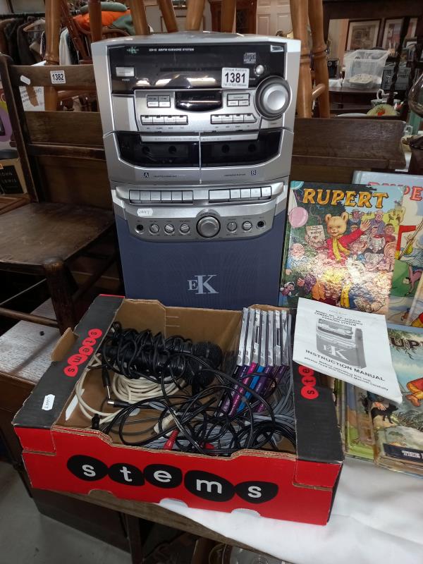 A compact disc karaoke system with 2 microphones, instructions, wires & some karaoke CD's (system