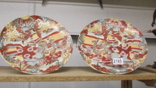 A pair of left and right facing 19th century hand painted signed Japanese Satsuma plates, 31 cm dia.