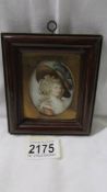 An old oval framed and glazed unsigned miniature portrait of a lady.