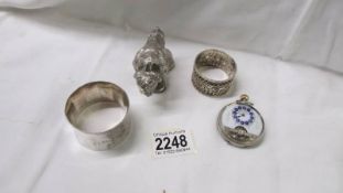 An old silver pocket watch a/f, a white metal buffalo and two white metal napkin rings.