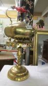 A brass kettle on a brass trivet.