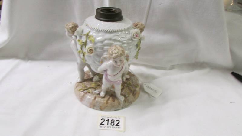 A continental porcelain cherub oil lamp base.