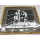 . A black and white photograph/print of the boxing match between Muhammad Ali and Henry Cooper