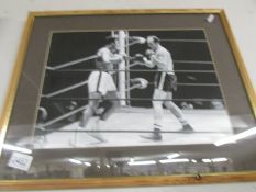 . A black and white photograph/print of the boxing match between Muhammad Ali and Henry Cooper