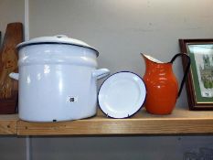 A large lidded enamel stew pot, plate and orange enamel jug