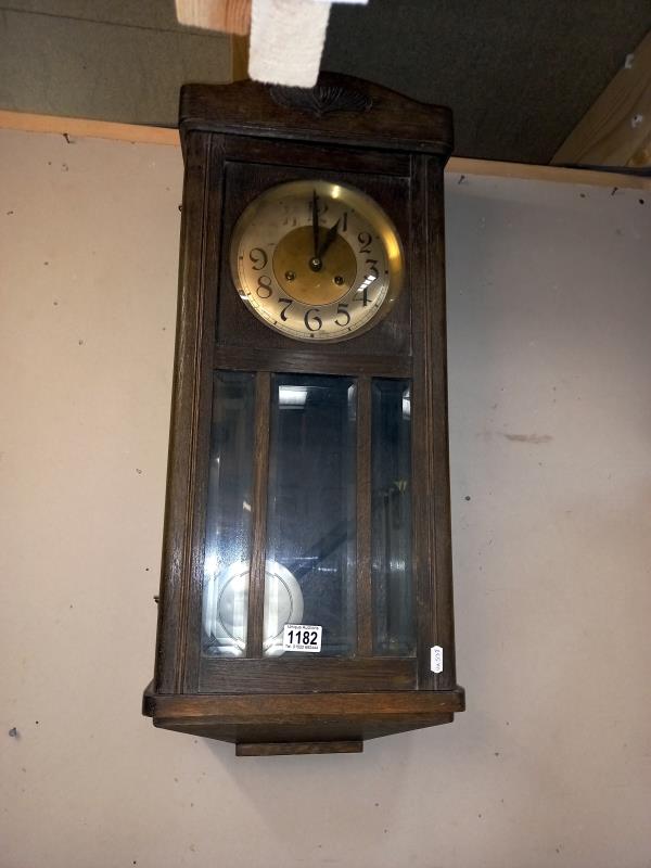 A 1930's oak wall clock