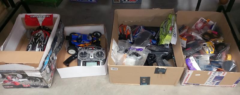 2 remote control off road cars (1 petrol engined) plus controllers & 2 boxes of spare parts (4