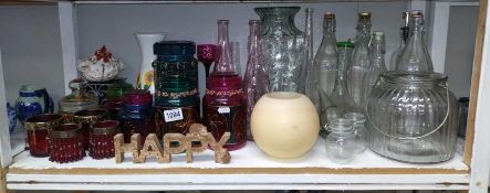 A good lot of decorative glass including bottles, candle holders etc.,