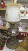 A Victorian brass oil lamp with later shade. COLLECT ONLY.