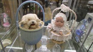 A musical dog in basket and a musical doll in basket.