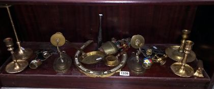 A selection of metalware, mainly brass items including cow bells, candlestick holders & ornaments