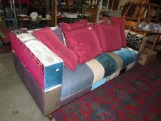 A patchwork design upholstered sofa in good condition. COLLECT ONLY.