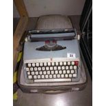 A vintage cased Brother de-luxe typewriter