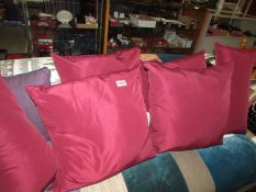 Six burgundy coloured cushions (4 large and 2 smaller)