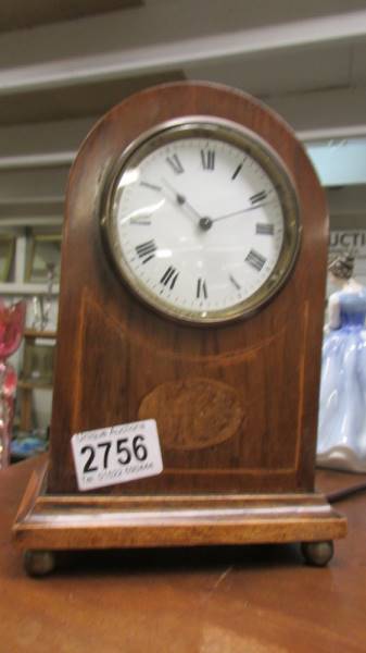 An Edwardian mahogany inlaid mantel clock in working order.