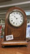 An Edwardian mahogany inlaid mantel clock in working order.