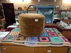 A hand crocheted blanket and a small pouffe