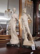A pair of Grecian style figures on marble bases.