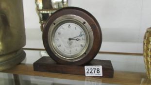 A 1920's Smiths, Cricklewood Clock Works, London car clock mounted in a wooden case.