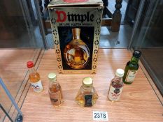 A boxed Dimple deluxe Scotch whisky and 5 miniatures.