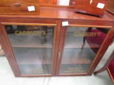 A two door glazed display cabinet signwritten for Cadbury, COLLECT ONLY.