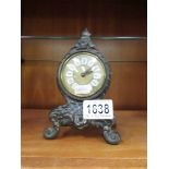 A small metal mantel clock.