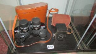A cased pair of Capitar binoculars and a Kodak 127 box camera.