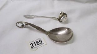 A Sterling silver spoon by Georg Jenson & Wendel A/S and a small ladle (possibly silver).