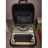 A cased vintage typewriter, name badge indistinct