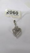 A white gold and diamond heart pendant, 3.7 grams.