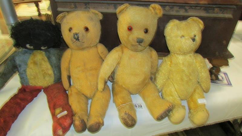 Three old Teddy bears and a golly.