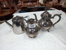 A silver plate teapot, silver plate water jug & an old stainless steel teapot