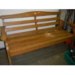 A wooden garden bench, 158cm wide (needs 3 nuts to back and varnishing.) COLLECT ONLY.
