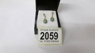 A pair of yellow gold emerald and diamond earrings,.