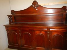 A large mahogany sideboard with 4 arch panel doors and drawers, 200cm wide x 50cm deep, height 77cm.