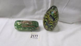 An unusual glass paperweight and an oblong glass paperweight.