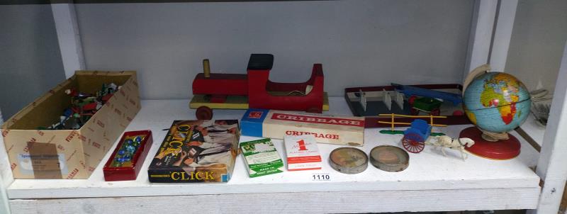 A shelf of vintage toys & games including plastic soldiers & marbles etc.