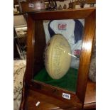 A cased signed World cup and Grand Slam rugby ball presented to RAF Wyton RUFC