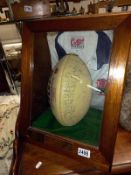 A cased signed World cup and Grand Slam rugby ball presented to RAF Wyton RUFC