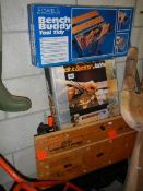 A portable folding saw bench, a Powell bench buddy in box and a Black & Decker jobber in box,