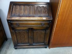 A linenfold bureau with key. COLLECT ONLY