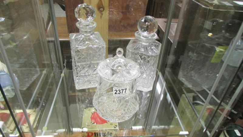 Two cut glass decanter and a cut glass biscuit/cookie jar.