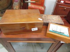A mahogany work box, a carved box and one other.