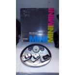 A boxed BMW new Mini Cooper diorama and 3 model cars set (box is a/f)