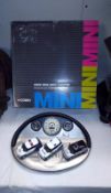 A boxed BMW new Mini Cooper diorama and 3 model cars set (box is a/f)